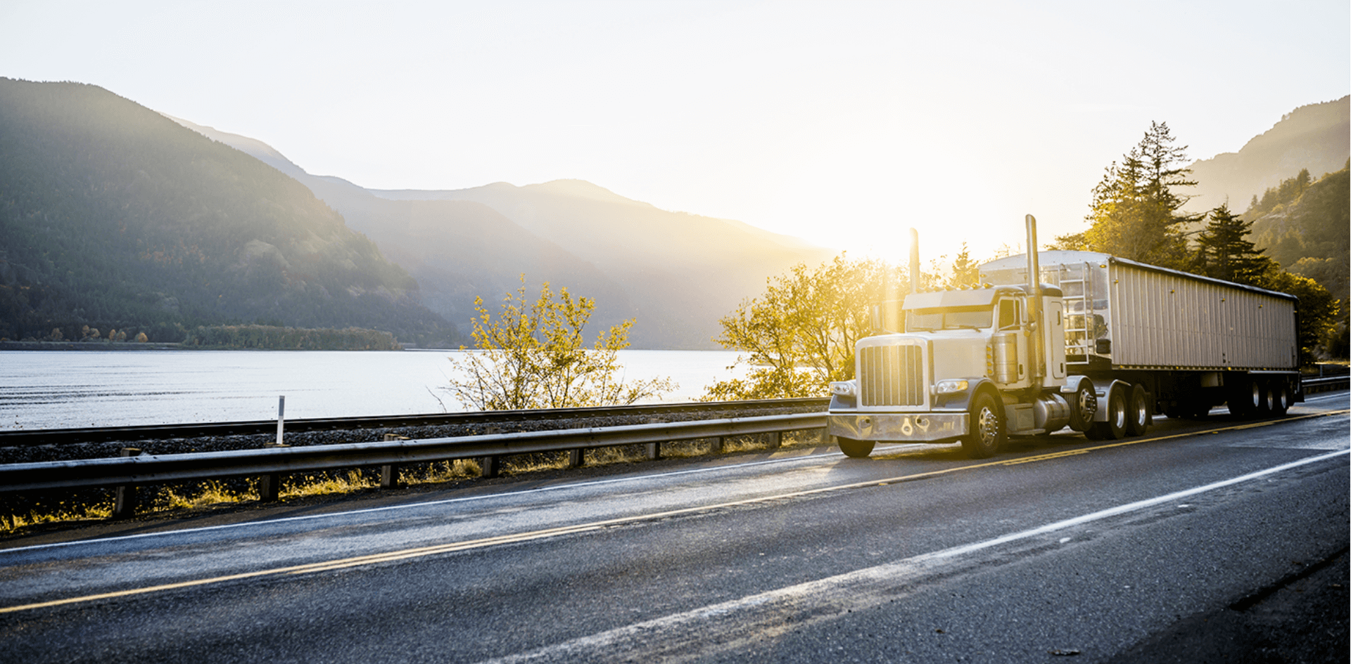 Semi truck and trailer driving on an open road